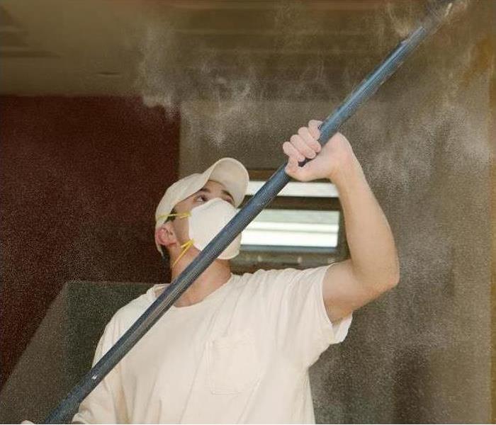 Man fixing plaster ceiling